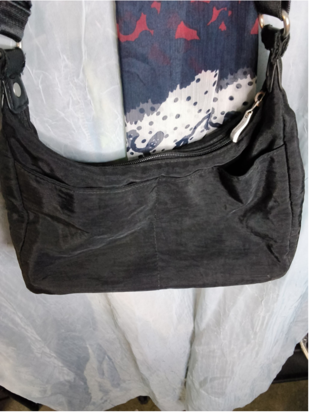 black nylon Baggallini hobo or crossbody bag, known for its lightweight